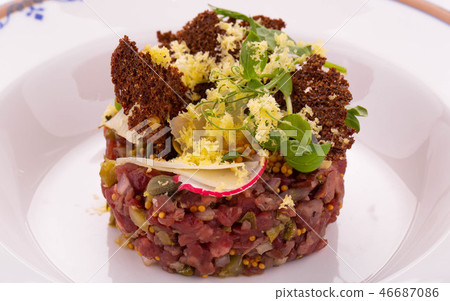The meat Tartar with grain toasts, vegetables and The meat Tartar with grain toasts, vegetables and 46687086