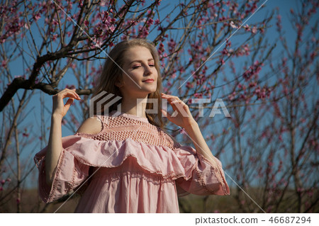 beautiful blonde woman in a flowered garden beautiful blonde woman in a flowered garden 46687294