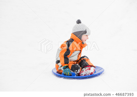 Happy laughing small boy slides down the hill 46687393