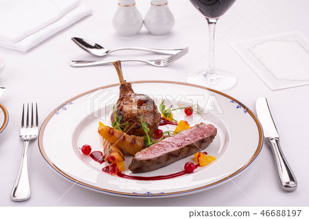 A leg of a turkey with the vegetables fried on a g A leg of a turkey with the vegetables fried on a g 46688197