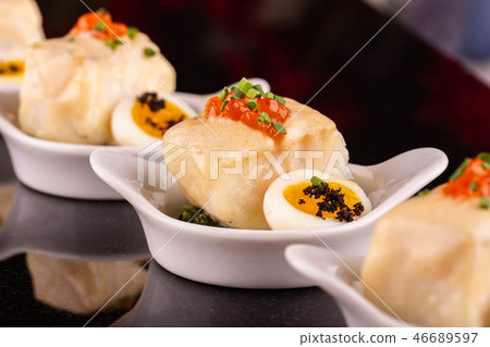 Fish fried with red caviar and quail egg 46689597