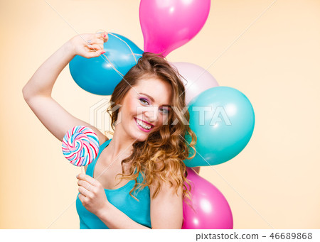 Woman with colorful balloons and lollipop Woman with colorful balloons and lollipop 46689868