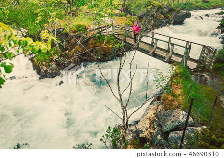 Tourist on river bridge, Norway Tourist on river bridge, Norway 46690310