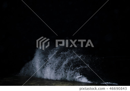 Splashing wave on the Black sea in the night. 46690843