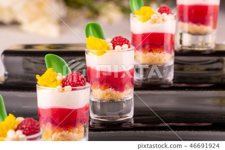 The crimson mousse dessert decorated with leaves f The crimson mousse dessert decorated with leaves f 46691924