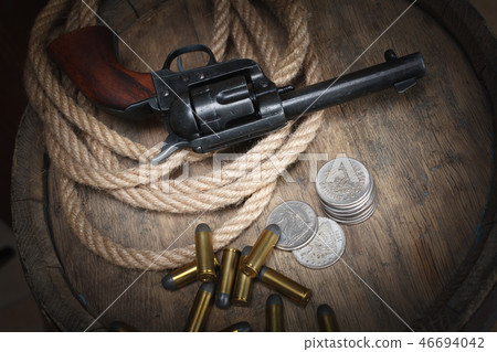 Old western revolver with cartridges and dollar Old western revolver with cartridges and dollar 46694042
