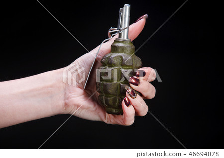 fragmentation grenade in girl hand 46694078