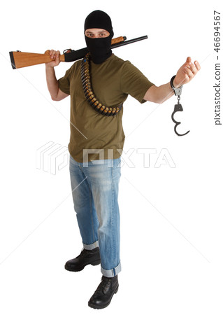 prison break - robber in black mask with shotgun removing handcuffs isolated on white background prison break - robber in black mask with shotgun removing handcuffs isolated on white background 46694567