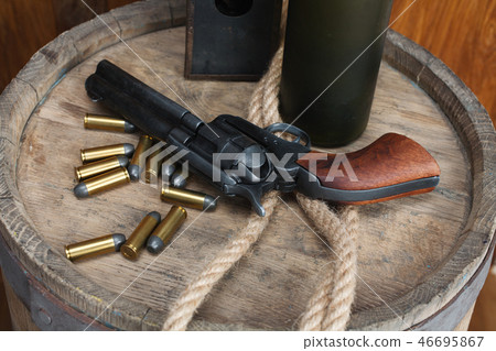 Old western revolver with cartridges 46695867