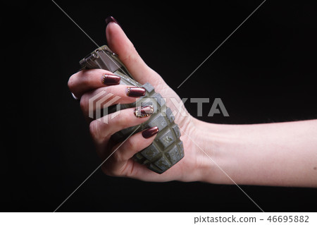 fragmentation grenade in woman hand fragmentation grenade in woman hand 46695882