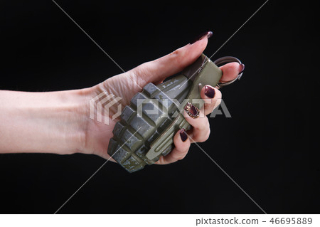 fragmentation grenade in woman hand fragmentation grenade in woman hand 46695889