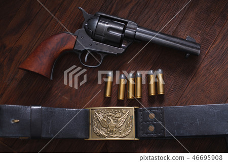 Old revolver with cartridges 46695908