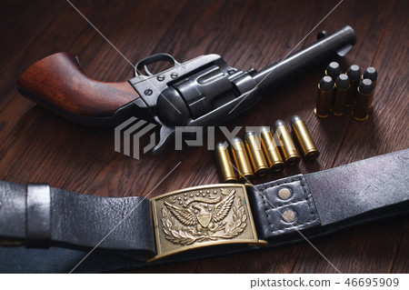 Old revolver with cartridges 46695909