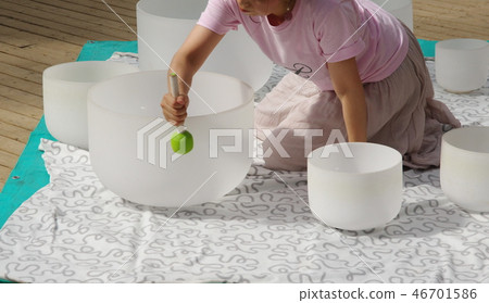 Crystal bowl playing Crystal bowl playing 46701586