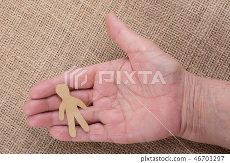 Paper man shape in hand in the view Paper man shape in hand in the view 46703297