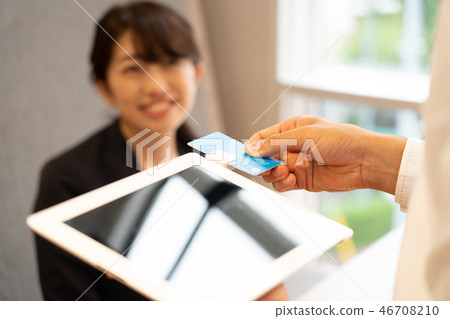 Woman doing cashless payment 46708210