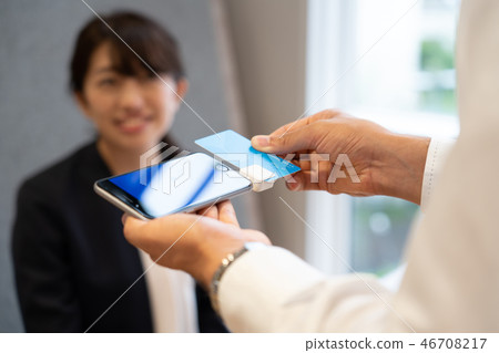 Woman doing cashless payment Woman doing cashless payment 46708217