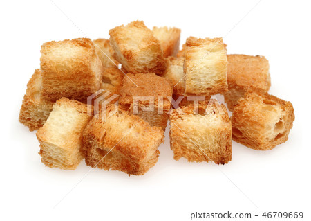 Tiny bread cubes on white background Tiny bread cubes on white background 46709669