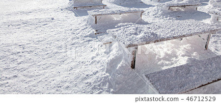 Winter snow loadings. Sun on desks and benches Winter snow loadings. Sun on desks and benches 46712529