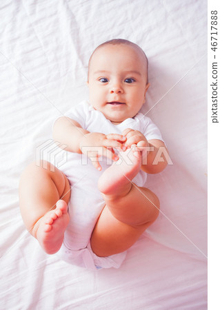 Portrait of a baby lying on the bed 46717888