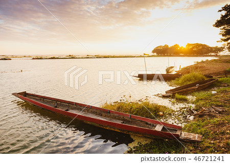 Fishing boats docked on the riverbank in sunset. 46721241