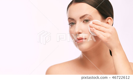 Home face care. Girl remove makeup. Woman hand 46722612