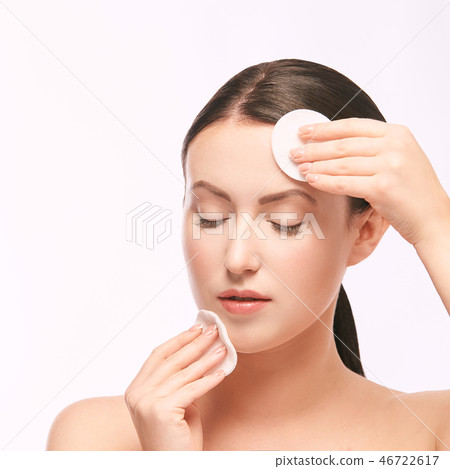Home face care. Girl remove makeup. Woman hand Home face care. Girl remove makeup. Woman hand 46722617