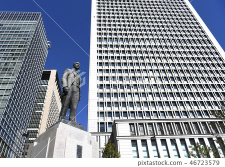 Tokyo cityscape in Japan A business area: A bronze statue of the "father of Japanese railway" re-established in the station square inside the Tokyo Station Maru 46723579