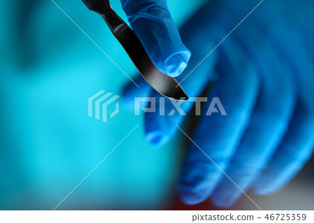 Surgeon arms in sterile uniform holding sharp knife Surgeon arms in sterile uniform holding sharp knife 46725359