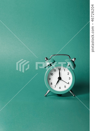 Green alarm clock on green backgrounds with space for text. Green alarm clock on green backgrounds with space for text. 46726204