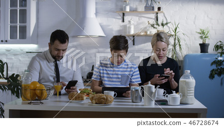 Family sitting at the kitchen table Family sitting at the kitchen table 46728674
