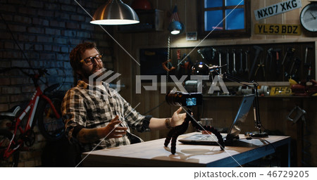 Young man talking on camera in a workshop 46729205