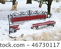 A forged metal bench and wood in the park are thrown in snow during the thaw 46730117