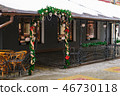 Entrance to the cafe is decorated with branches of fir trees and Christmas tree decorations in the 46730118