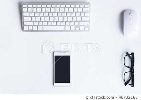 White desk office with laptop, smartphone and othe 46732165
