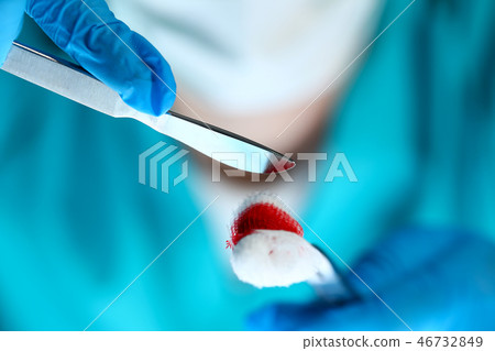 Surgeon in sterile uniform arms holding tools with bio material Surgeon in sterile uniform arms holding tools with bio material 46732849
