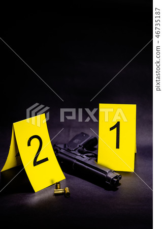 Bullets and gun at crime scene Bullets and gun at crime scene 46735187