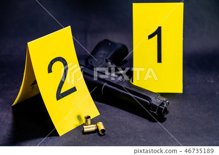 Bullets and gun at crime scene Bullets and gun at crime scene 46735189