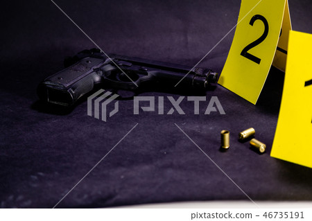 Bullets and gun at crime scene Bullets and gun at crime scene 46735191