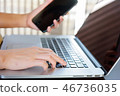 Closeup woman hand working on laptop and mobile  46736035
