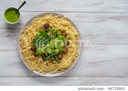 Pasta with meatballs and spinach sauce. Top view. 46738861