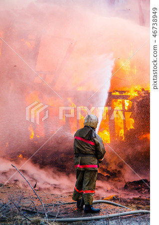 Fireman extinguishes a fire 46738949