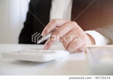 businessman using the calculator about investment 46739254