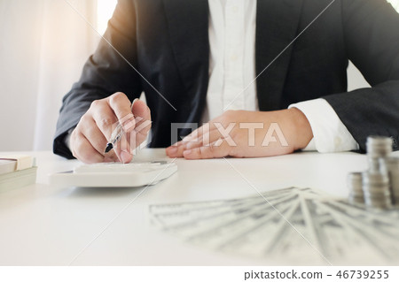 businessman using the calculator about investment 46739255