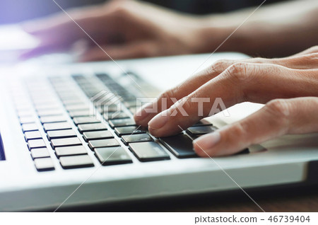 close up hands typing keyboard laptop 46739404