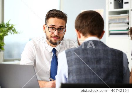 Two smiling clerk businessmen deliberate on problem Two smiling clerk businessmen deliberate on problem 46742194