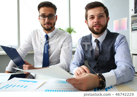 Group of businessmen with financial graph and silver pen 46742229
