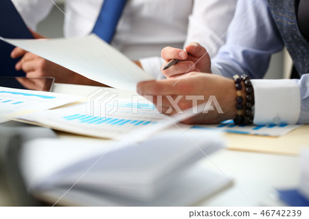 Group of businessmen with financial graph and silver pen 46742239