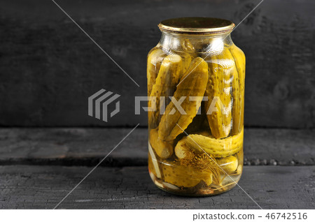 pickled homemade cucumbers in a glass jar 46742516