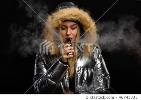 Young sexy woman is vaping.  46743333